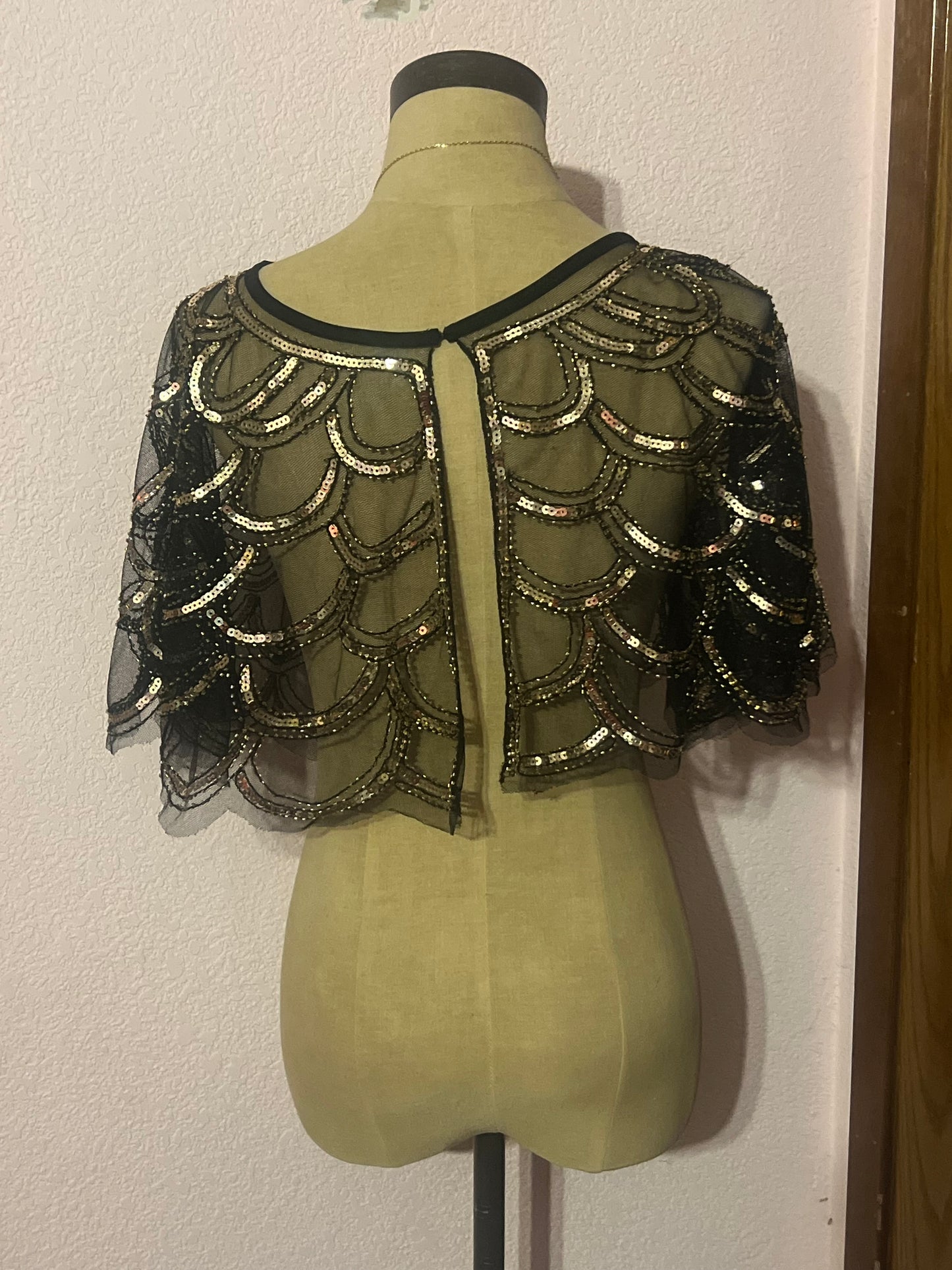 Gold and black sequin capelet with a boho vibe