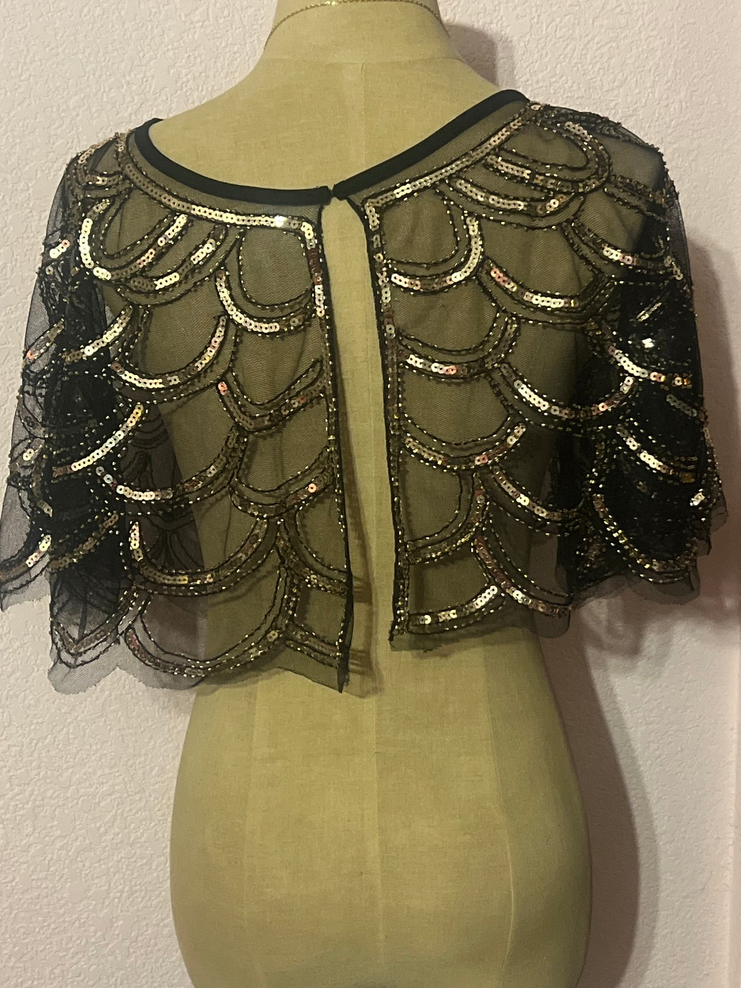 Gold and black sequin capelet with a boho vibe