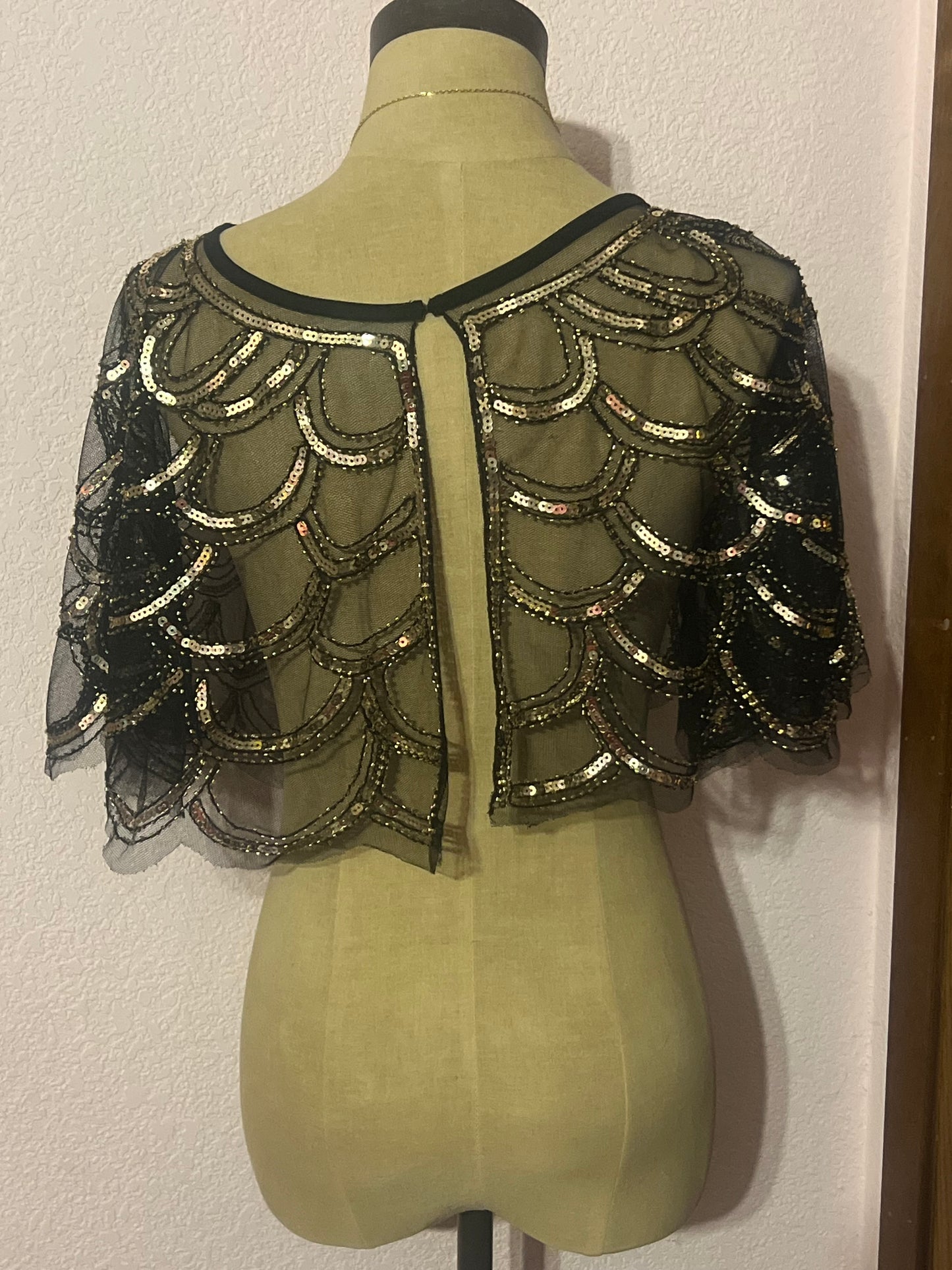 Gold and black sequin capelet with a boho vibe