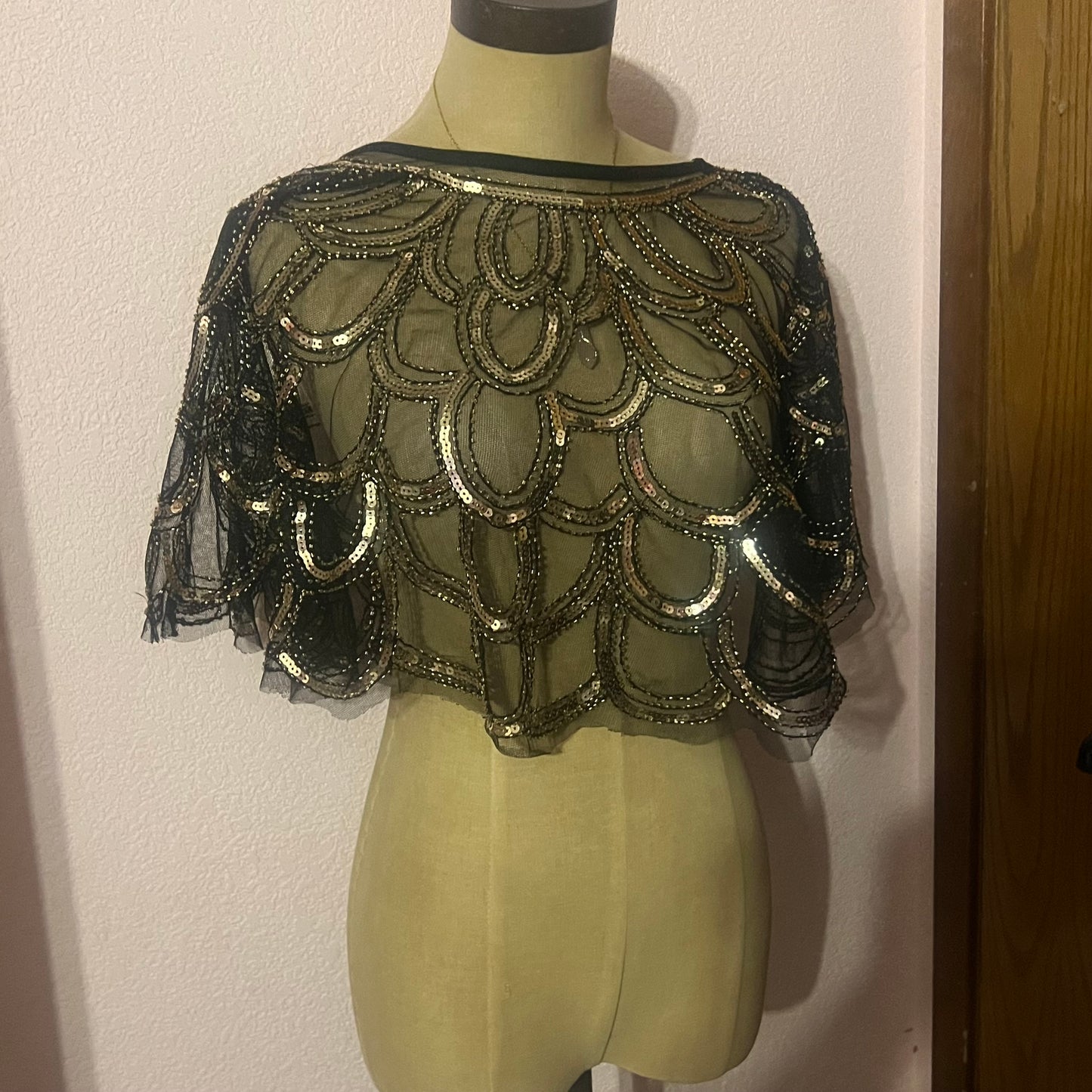 Gold and black sequin capelet with a boho vibe